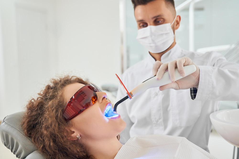 girl-lying-chair-while-dentist-keeping-ultraviolet-tool