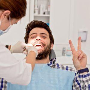 young happy man and woman in a dental examination at dentist
